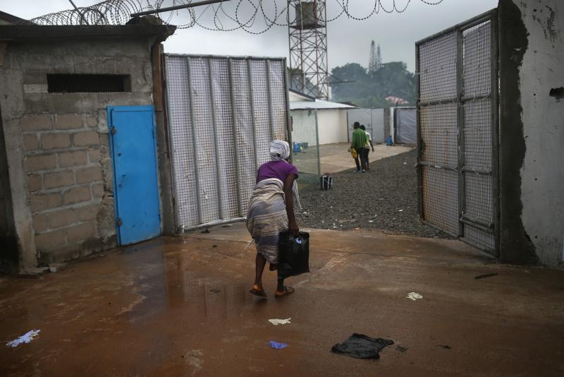 A woman enters the Ebola treatment center at the Island Hospital outside of Monrovia, Liberia, Oct. 6. She said she was bleeding heavily from a miscarriage and was turned away from other clinics in the city. A woman enters the Ebola treatment center at the Island Hospital outside of Monrovia, Liberia, Oct. 6. She said she was bleeding heavily from a miscarriage and was turned away from other clinics in the city.