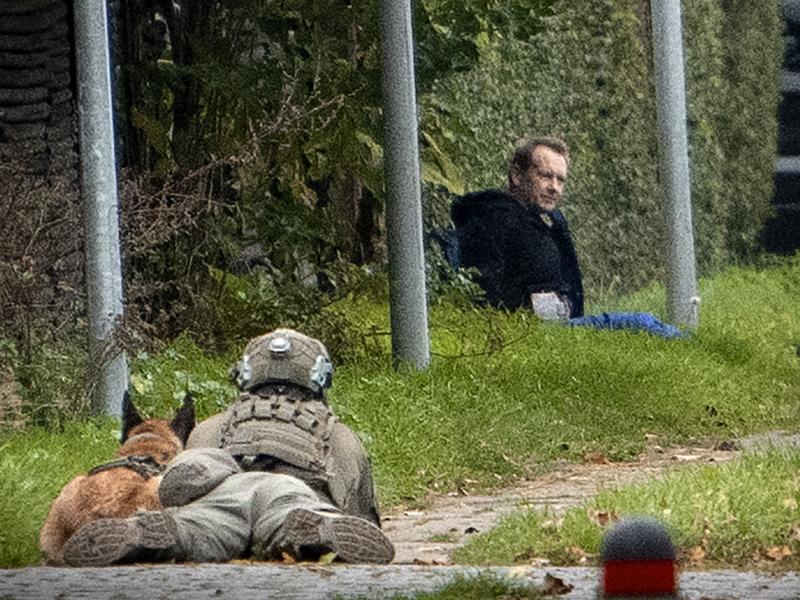 A police marksman and his dog observes convicted killer Peter Madsen threatening police with detonating a bomb while attempting to break out of jail Tuesday in Albertslund, Denmark. A police marksman and his dog observes convicted killer Peter Madsen threatening police with detonating a bomb while attempting to break out of jail Tuesday in Albertslund, Denmark.