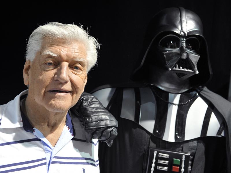 British actor David Prowse, who played Darth Vader in the first Star Wars trilogy, poses with a fan dressed in a Darth Vader costume during a Star Wars convention on April 27, 2013. On Sunday morning, Prowse's management company shared the news of his dea British actor David Prowse, who played Darth Vader in the first Star Wars trilogy, poses with a fan dressed in a Darth Vader costume during a Star Wars convention on April 27, 2013. On Sunday morning, Prowse's management company shared the news of his dea