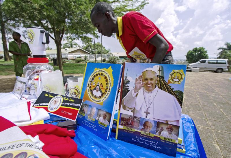 A vendor arranges portraits of Pope Francis outside the Lubaga Cathedral in Kampala, Uganda, in preparation for the papal visit. A vendor arranges portraits of Pope Francis outside the Lubaga Cathedral in Kampala, Uganda, in preparation for the papal visit.