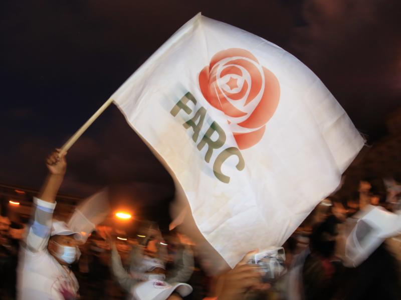 A former FARC guerrilla member waves a FARC political party flag during a demonstration in Bogota on Nov. 2. A federal court overturned an asylum decision Wednesday, holding that FARC death threats counted as persecution.× A former FARC guerrilla member waves a FARC political party flag during a demonstration in Bogota on Nov. 2. A federal court overturned an asylum decision Wednesday, holding that FARC death threats counted as persecution.×