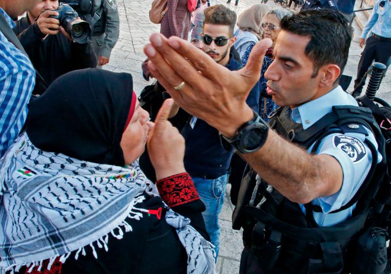 A Palestinian woman argues with a member of the Israeli security forces as they disperse a demonstration outside the Damascus Gate in the old city of Jerusalem on Tuesday. A Palestinian woman argues with a member of the Israeli security forces as they disperse a demonstration outside the Damascus Gate in the old city of Jerusalem on Tuesday.