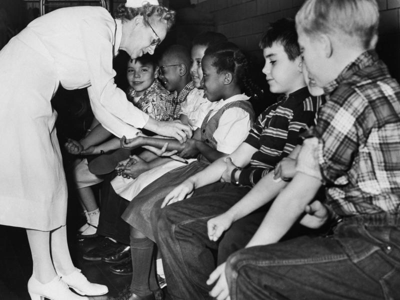 A nurse prepares children for a polio vaccine shot as part of citywide testing of the vaccine on elementary school students in Pittsburgh in 1954. A nurse prepares children for a polio vaccine shot as part of citywide testing of the vaccine on elementary school students in Pittsburgh in 1954.