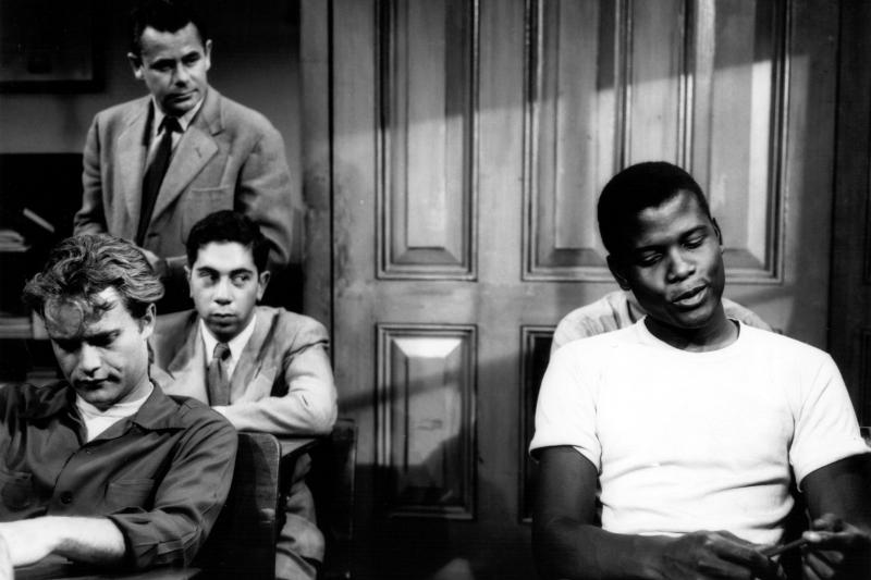 Sidney Poitier (right) and Glenn Ford (standing) in the 1955 film Blackboard Jungle. Sidney Poitier (right) and Glenn Ford (standing) in the 1955 film Blackboard Jungle.