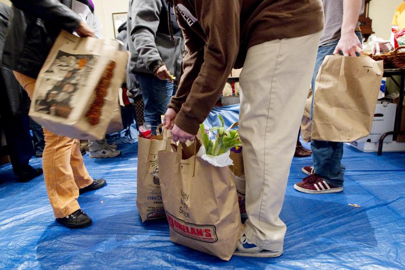 Volunteers gather bags of groceries for people seeking assistance at a food pantry in Concord, Mass. Many groups that help low-income families get food aid say they've seen an alarming drop recently in the number of immigrants applying for help. Volunteers gather bags of groceries for people seeking assistance at a food pantry in Concord, Mass. Many groups that help low-income families get food aid say they've seen an alarming drop recently in the number of immigrants applying for help.