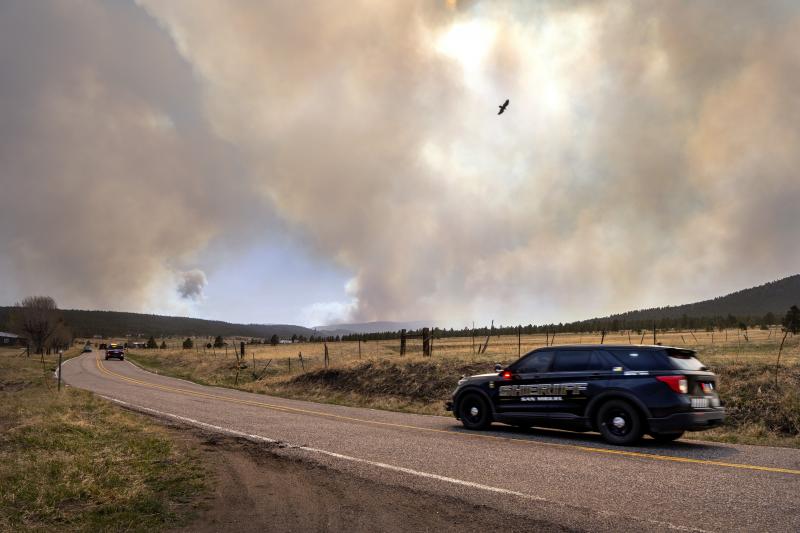San Miguel County Sheriff's Officers patrol N.M. 94 near Penasco Blanco, N.M., as the Calf Fire burns nearby on Friday. San Miguel County Sheriff's Officers patrol N.M. 94 near Penasco Blanco, N.M., as the Calf Fire burns nearby on Friday.