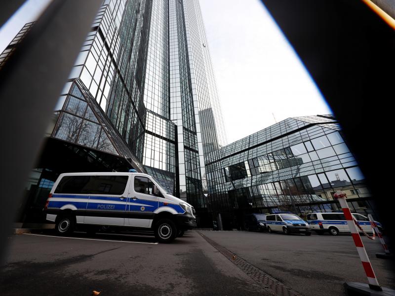 Police vehicles are parked in front of Deutsche Bank headquarters as roughly 170 officers, prosecutors and tax inspectors searched the bank's offices in and around Frankfurt, Germany, on Thursday. Police vehicles are parked in front of Deutsche Bank headquarters as roughly 170 officers, prosecutors and tax inspectors searched the bank's offices in and around Frankfurt, Germany, on Thursday.