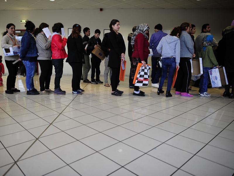 Migrants and refugees seeking asylum in Sarstedt, Germany, line up Feb. 26 for lunch at the shelter where they live while their asylum applications are processed. Germany wants to send more migrants home and sent a charter plane filled with Afghan migrant Migrants and refugees seeking asylum in Sarstedt, Germany, line up Feb. 26 for lunch at the shelter where they live while their asylum applications are processed. Germany wants to send more migrants home and sent a charter plane filled with Afghan migrant