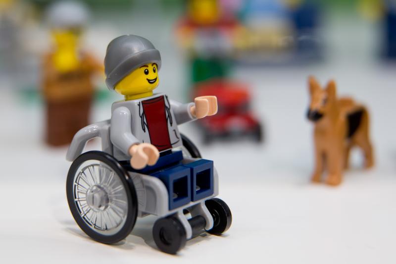 A Lego figure in a wheelchair was introduced at the 67th International Toy Fair in January 2016. He comes in the "City" set, a community of figures shown playing and working in an urban park setting. A Lego figure in a wheelchair was introduced at the 67th International Toy Fair in January 2016. He comes in the "City" set, a community of figures shown playing and working in an urban park setting.