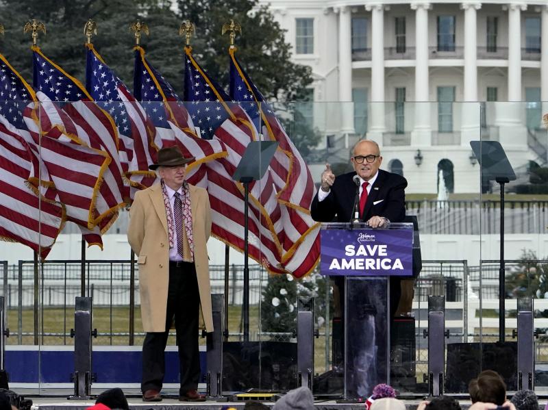 Rudy Giuliani, seen here on Jan. 6 with Chapman University law professor John Eastman, speaks in Washington at a rally in support of former President Donald Trump. Dominion Voting Systems, a frequent target of Giuliani, is suing him for defamation. Rudy Giuliani, seen here on Jan. 6 with Chapman University law professor John Eastman, speaks in Washington at a rally in support of former President Donald Trump. Dominion Voting Systems, a frequent target of Giuliani, is suing him for defamation.
