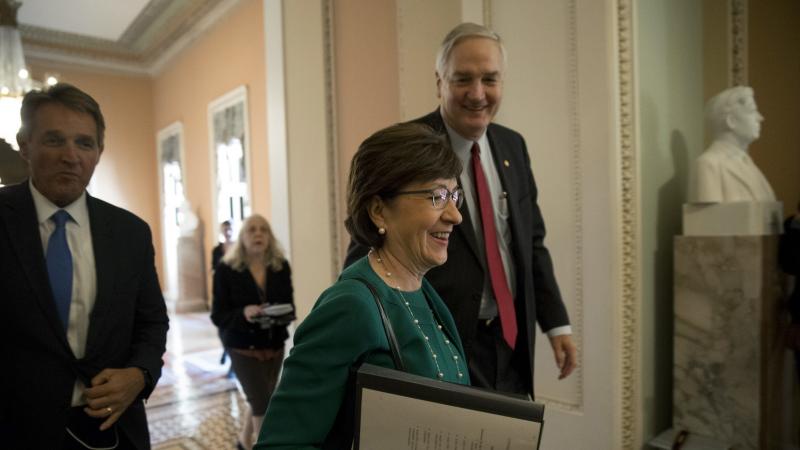 Sen. Susan Collins, a Republican from Maine, walks through the Capitol with colleagues in early December. Sen. Susan Collins, a Republican from Maine, walks through the Capitol with colleagues in early December.