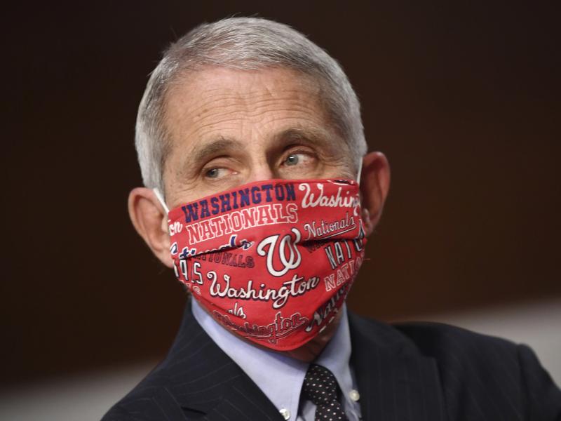 Dr. Anthony Fauci, director of the National Institute for Allergy and Infectious Diseases wore a Washington Nationals face mask before testifying at a congressional hearing on June 30. The team announced he will throw out the ceremonial first pitch at the Dr. Anthony Fauci, director of the National Institute for Allergy and Infectious Diseases wore a Washington Nationals face mask before testifying at a congressional hearing on June 30. The team announced he will throw out the ceremonial first pitch at the