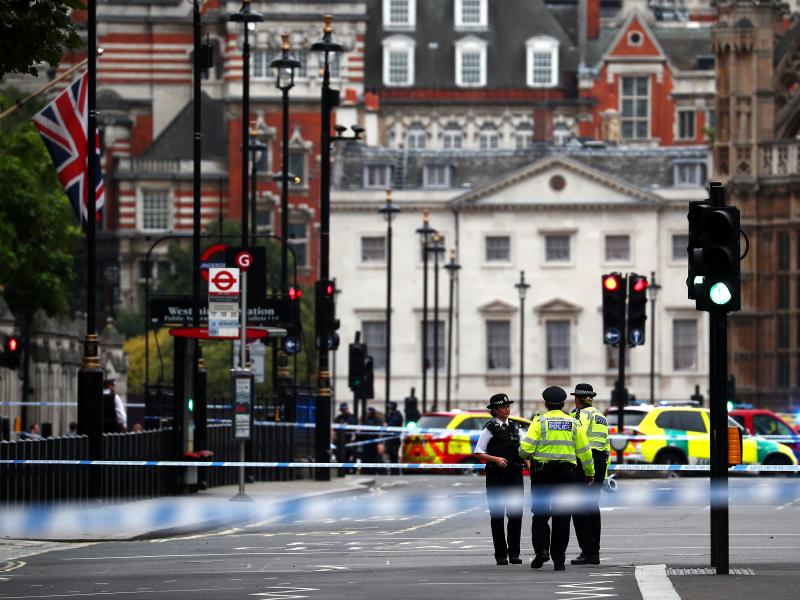 Police stand in the street after a car crashed outside the Houses of Parliament in Westminster, London, on Tuesday. Police stand in the street after a car crashed outside the Houses of Parliament in Westminster, London, on Tuesday.