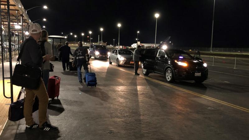 Travelers wait at the ride-share pickup location at Sacramento International Airport. Uber is allowing drivers at three California airports to set their own fares. Travelers wait at the ride-share pickup location at Sacramento International Airport. Uber is allowing drivers at three California airports to set their own fares.