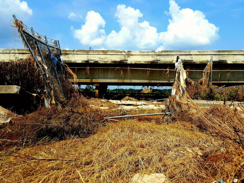 Floodwaters from Hurricane Harvey ripped apart fences and flooded Interstate 10 east of Houston last year. The San Jacinto Waste Pits Superfund site is on the other side of the road. Floodwaters from Hurricane Harvey ripped apart fences and flooded Interstate 10 east of Houston last year. The San Jacinto Waste Pits Superfund site is on the other side of the road.