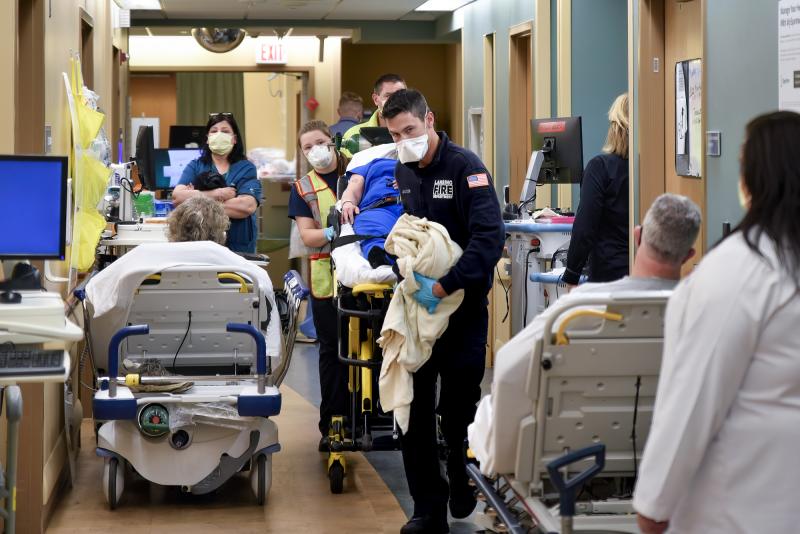 An ambulance crew weaves a gurney through the halls of Sparrow Hospital's emergency department in Lansing, Michigan. Overcrowding has forced the staff to triage patients, putting some in the waiting rooms and treating others on stretchers and chairs in th An ambulance crew weaves a gurney through the halls of Sparrow Hospital's emergency department in Lansing, Michigan. Overcrowding has forced the staff to triage patients, putting some in the waiting rooms and treating others on stretchers and chairs in th