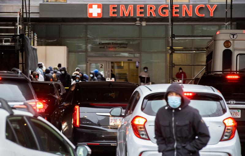 People and cars line up outside of Boston Medical Center near the emergency room where COVID-19 testing was taking place during the Omicron surge in Boston on Jan. 3, 2022. People and cars line up outside of Boston Medical Center near the emergency room where COVID-19 testing was taking place during the Omicron surge in Boston on Jan. 3, 2022.