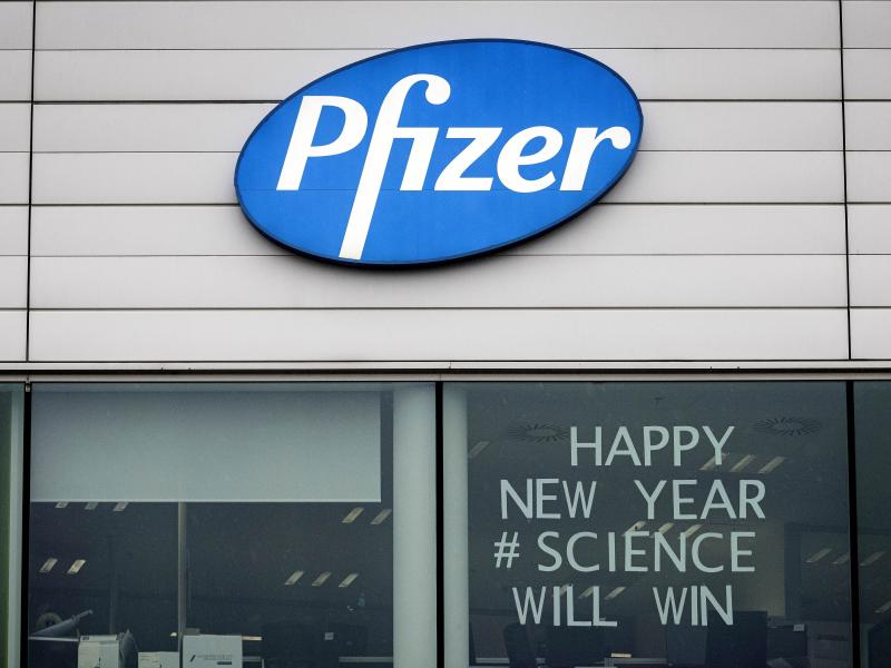 A sign appears in the window of an office at Pfizer Manufacturing in Puurs, Belgium, on Monday, the same day the European Medicines Agency authorized the use of the company's COVID-19 vaccine. A sign appears in the window of an office at Pfizer Manufacturing in Puurs, Belgium, on Monday, the same day the European Medicines Agency authorized the use of the company's COVID-19 vaccine.