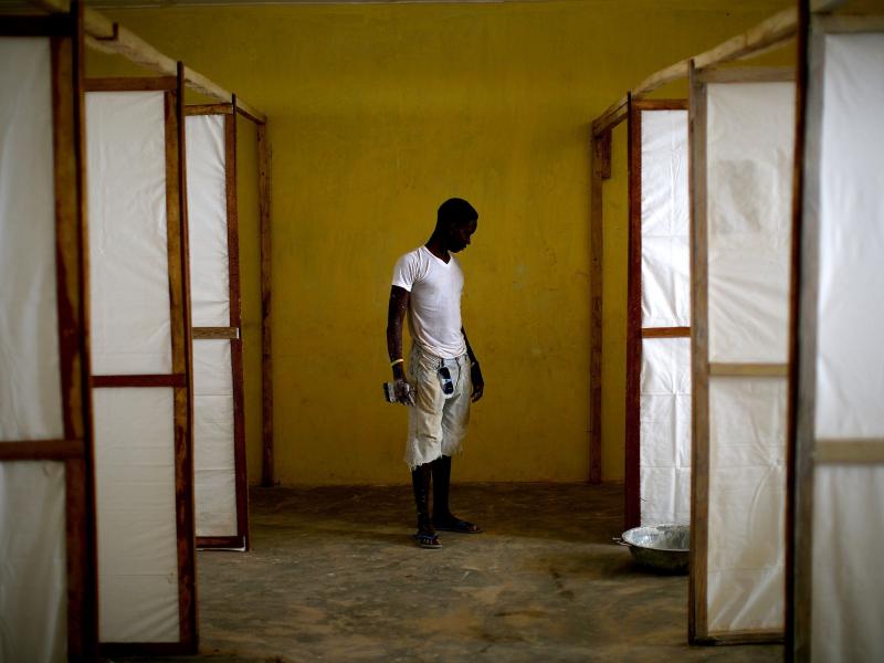 In November 2014, a worker stands by dividers to separate patients in an Ebola treatment facility under construction in the Port Loko district of Sierra Leone. In November 2014, a worker stands by dividers to separate patients in an Ebola treatment facility under construction in the Port Loko district of Sierra Leone.