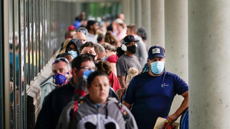 Hundreds of people line up outside a Kentucky Career Center hoping to find assistance with their unemployment claim in Frankfort, Ky., in June. Hundreds of people line up outside a Kentucky Career Center hoping to find assistance with their unemployment claim in Frankfort, Ky., in June.