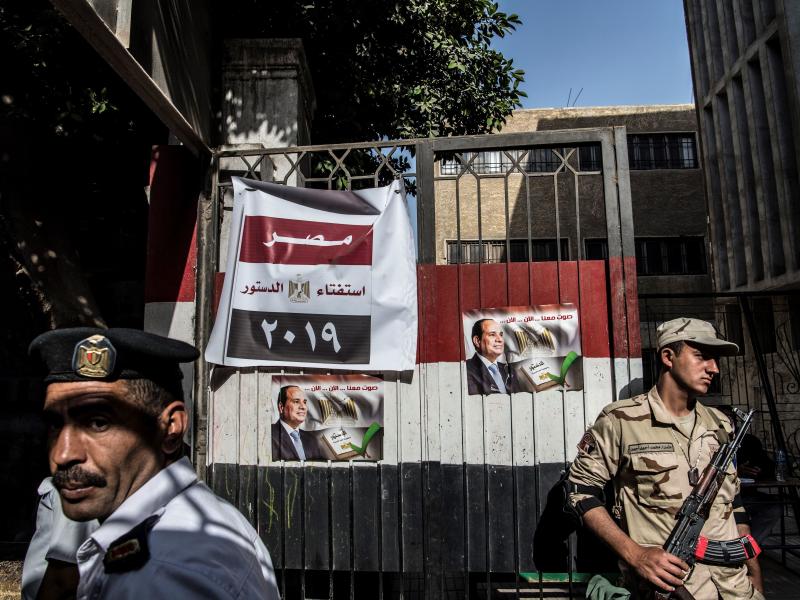 An Egyptian soldier and a policeman stand guard at a Cairo polling station on Monday, the third day of a referendum on constitutional amendments. An Egyptian soldier and a policeman stand guard at a Cairo polling station on Monday, the third day of a referendum on constitutional amendments.