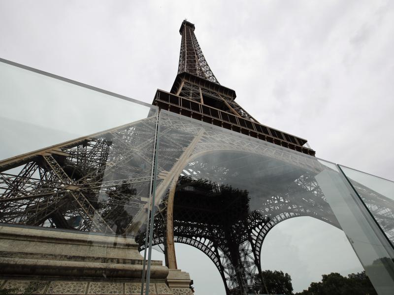 Newly installed panels of bulletproof glass surround two sides of the Eiffel Tower site in Paris. Construction is scheduled to be complete in July. Newly installed panels of bulletproof glass surround two sides of the Eiffel Tower site in Paris. Construction is scheduled to be complete in July.