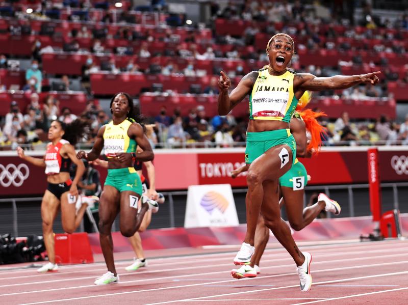 Elaine Thompson-Herah of Team Jamaica crosses the finish line to win the gold medal in the women's 100-meter final at the Tokyo Olympic Games on Saturday. Elaine Thompson-Herah of Team Jamaica crosses the finish line to win the gold medal in the women's 100-meter final at the Tokyo Olympic Games on Saturday.