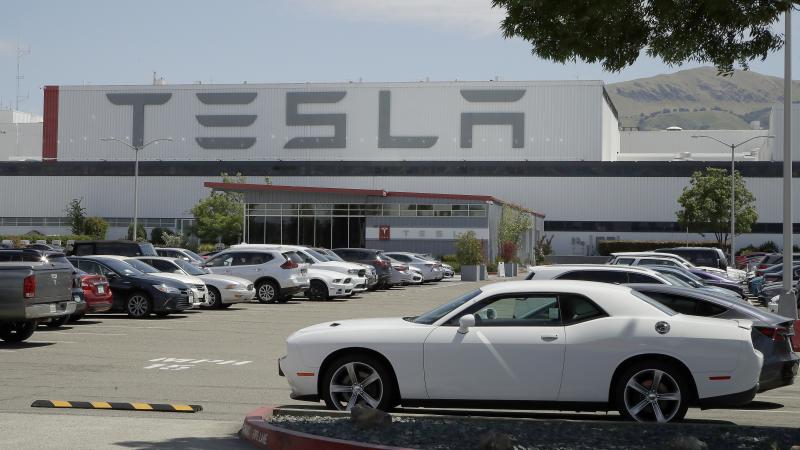 Vehicles are seen parked at the Tesla car plant in Fremont, Calif., on Monday. The parking lot was nearly full; Tesla resumed production in defiance of an order from county health authorities. Vehicles are seen parked at the Tesla car plant in Fremont, Calif., on Monday. The parking lot was nearly full; Tesla resumed production in defiance of an order from county health authorities.