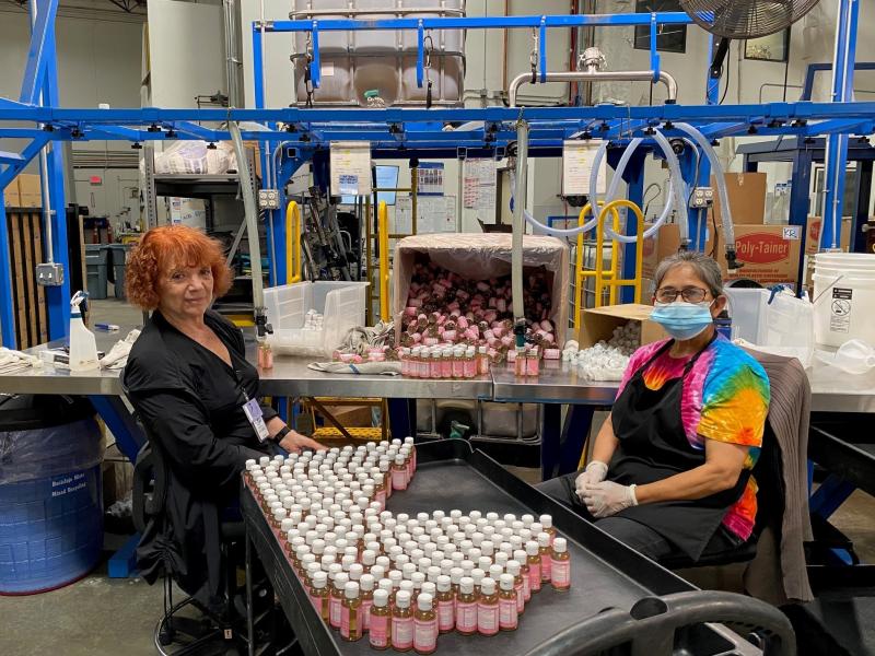 Alice Gomez and Maria Ramos work at Dr. Bronner's soap factory in Vista, Calif. The company is doing weekly coronavirus testing but still wants all its workers vaccinated. Alice Gomez and Maria Ramos work at Dr. Bronner's soap factory in Vista, Calif. The company is doing weekly coronavirus testing but still wants all its workers vaccinated.