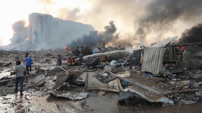 Firefighters extinguish flames at nearby damaged buildings following a large explosion at the Port of Beirut in Lebanon on Tuesday. Firefighters extinguish flames at nearby damaged buildings following a large explosion at the Port of Beirut in Lebanon on Tuesday.