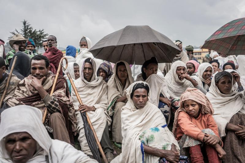 People who fled from fighting in Ethiopia gather in a temporary internally displaced people camp to receive first bags of wheat from the World Food Programme. Ethiopia saw a record 5.1 million displacements in 2021. People who fled from fighting in Ethiopia gather in a temporary internally displaced people camp to receive first bags of wheat from the World Food Programme. Ethiopia saw a record 5.1 million displacements in 2021.