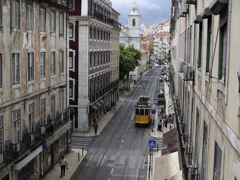 A tram drives through an empty downtown Lisbon, Portugal, on Friday. Portuguese authorities banned all weekend travel in and out of the capital to cut down on any further spread of the coronavirus to other parts of the country. A tram drives through an empty downtown Lisbon, Portugal, on Friday. Portuguese authorities banned all weekend travel in and out of the capital to cut down on any further spread of the coronavirus to other parts of the country.