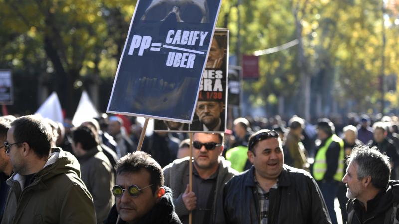 Europe's top court has ruled that Uber is a transportation company — not merely an e-commerce service. Here, a Spanish taxi driver is seen protesting against Uber and another service, Cabify, during cabdrivers' demonstration last month. Europe's top court has ruled that Uber is a transportation company — not merely an e-commerce service. Here, a Spanish taxi driver is seen protesting against Uber and another service, Cabify, during cabdrivers' demonstration last month.