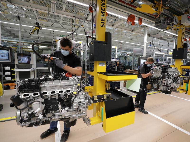 Employees assemble motors at a Mercedes-Benz factory in Stuttgart, Germany, on Wednesday. The German government pays much of laid-off workers' salaries for up to 12 months during economic crises. Employees assemble motors at a Mercedes-Benz factory in Stuttgart, Germany, on Wednesday. The German government pays much of laid-off workers' salaries for up to 12 months during economic crises.