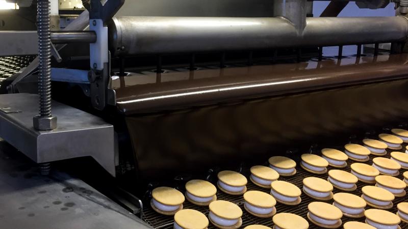 A machine coined "The Enrober" provides the "Willy Wonka moment" of MoonPie-making, when the treats are propelled under a gooey chocolate waterfall. A machine coined "The Enrober" provides the "Willy Wonka moment" of MoonPie-making, when the treats are propelled under a gooey chocolate waterfall.