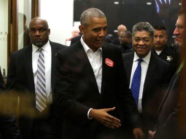 Former President Barack Obama extends his hand as he attends Cook County jury duty at the Daley Center on Wednesday in Chicago. Former President Barack Obama extends his hand as he attends Cook County jury duty at the Daley Center on Wednesday in Chicago.