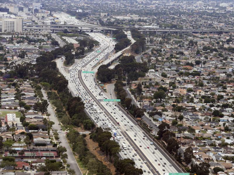 Interstate 405 cuts through neighborhoods near the Los Angeles International Airport, seen here in 2017. A new study found links between modern urban air pollution and historical redlining at the national level. Interstate 405 cuts through neighborhoods near the Los Angeles International Airport, seen here in 2017. A new study found links between modern urban air pollution and historical redlining at the national level.