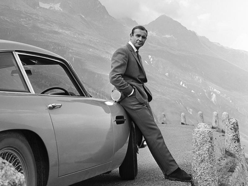 Actor Sean Connery poses as James Bond next to his Aston Martin DB5 in a scene from the United Artists release 'Goldfinger' in 1964. Actor Sean Connery poses as James Bond next to his Aston Martin DB5 in a scene from the United Artists release 'Goldfinger' in 1964.