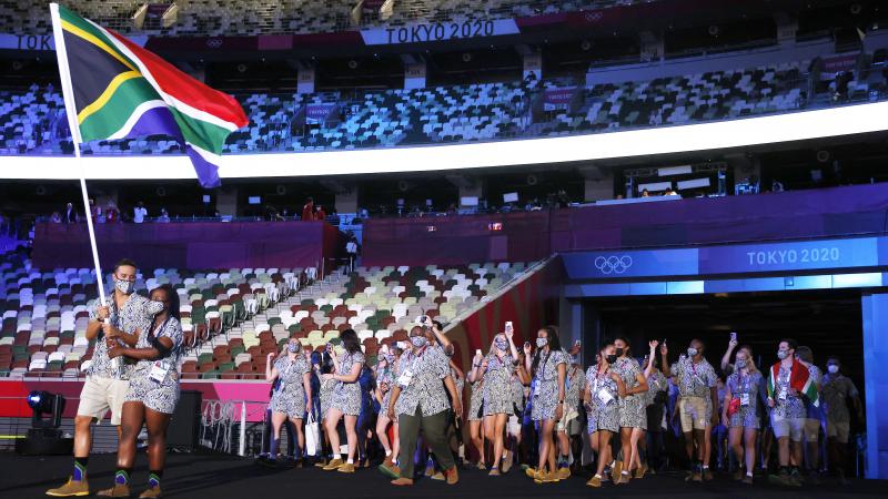 Flag bearers Phumelela Luphumlo Mbande and Chad Le Clos of Team South Africa lead their team out during the opening ceremony of the Tokyo Olympic Games on Friday. Flag bearers Phumelela Luphumlo Mbande and Chad Le Clos of Team South Africa lead their team out during the opening ceremony of the Tokyo Olympic Games on Friday.