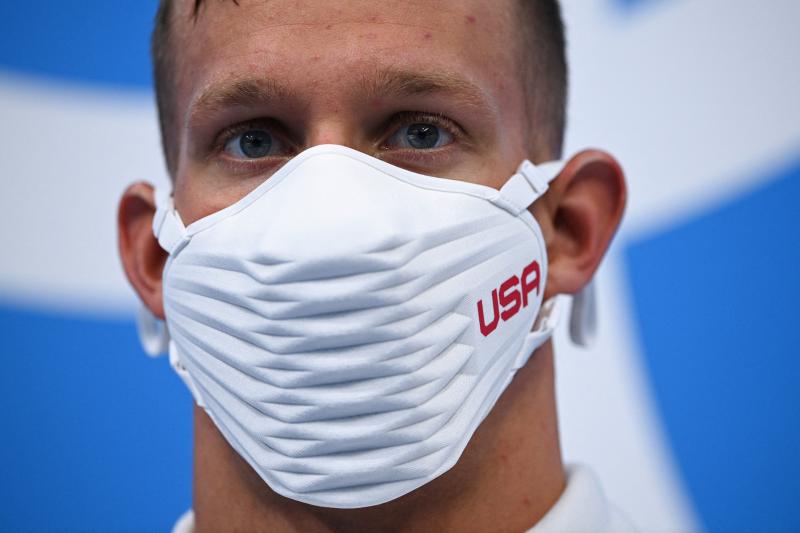 Team USA's Caeleb Dressel wears a USA-branded face covering while waiting to receive his gold medal after the final of the men's 4x100 meter freestyle relay swimming event during the Tokyo Olympics at the Tokyo Aquatics Centre on Monday. Team USA's Caeleb Dressel wears a USA-branded face covering while waiting to receive his gold medal after the final of the men's 4x100 meter freestyle relay swimming event during the Tokyo Olympics at the Tokyo Aquatics Centre on Monday.