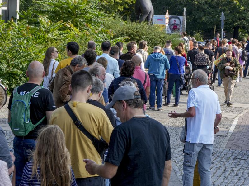 People queue in front of a polling station in the Moabit district of Berlin, Germany. German voters are choosing a new parliament in an election that will determine who succeeds Chancellor Angela Merkel after her 16 years at the helm of Europe's biggest e People queue in front of a polling station in the Moabit district of Berlin, Germany. German voters are choosing a new parliament in an election that will determine who succeeds Chancellor Angela Merkel after her 16 years at the helm of Europe's biggest e