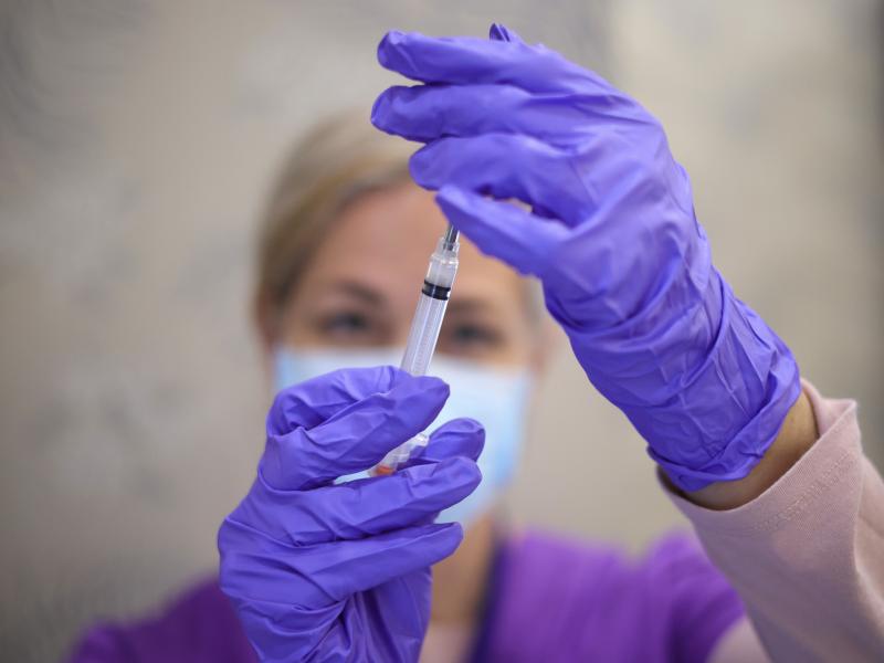 A nurse draws a vaccine dose from a vial of Moderna's COVID-19 vaccine at a community center in Bowie, Md., in March. A nurse draws a vaccine dose from a vial of Moderna's COVID-19 vaccine at a community center in Bowie, Md., in March.