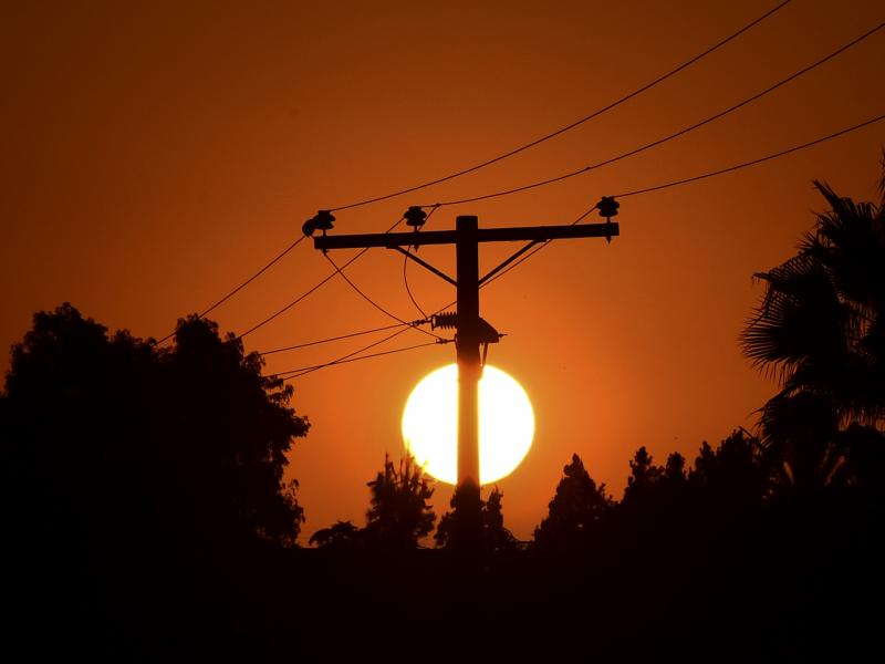 The sun sets behind power lines in Los Angeles in September. The sun sets behind power lines in Los Angeles in September.