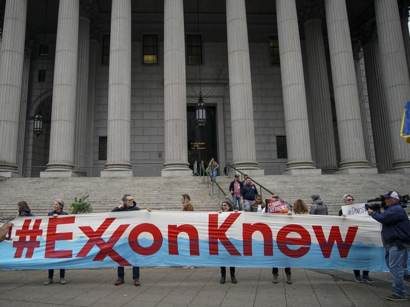 Environmental activists rally outside of New York Supreme Court in October in Manhattan, the first day of the trial accusing ExxonMobil of misleading shareholders about its climate change accounting. Environmental activists rally outside of New York Supreme Court in October in Manhattan, the first day of the trial accusing ExxonMobil of misleading shareholders about its climate change accounting.