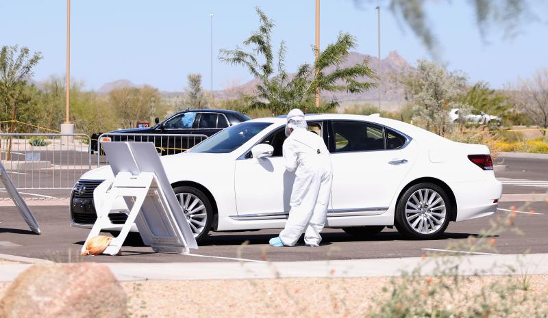 Health care professionals prepare to screen people for the coronavirus at a testing site in Phoenix, Arizona. Health care professionals prepare to screen people for the coronavirus at a testing site in Phoenix, Arizona.