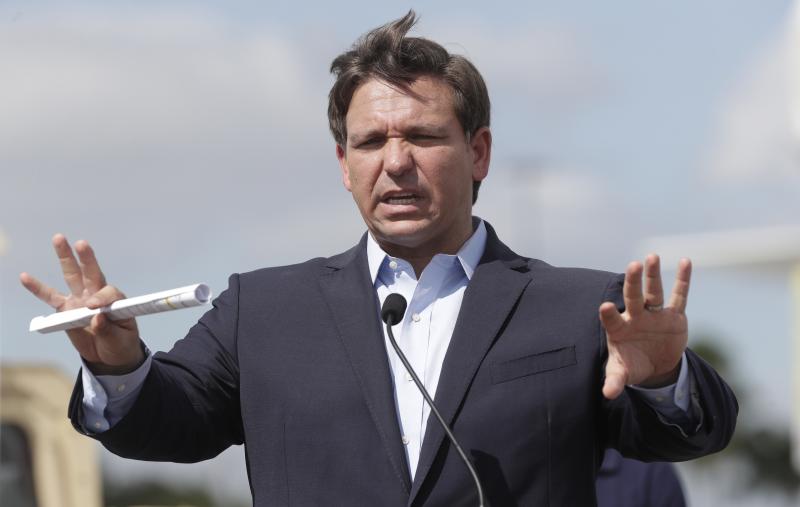 Florida Gov. Ron DeSantis speaks during a news conference at a drive-through coronavirus testing site in front of Hard Rock Stadium on Monday. Florida Gov. Ron DeSantis speaks during a news conference at a drive-through coronavirus testing site in front of Hard Rock Stadium on Monday.