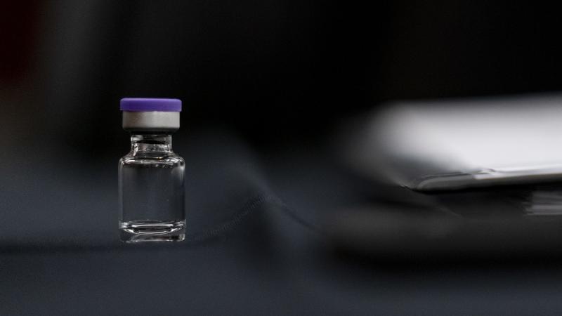An example of a vial that will carry the COVID-19 vaccine produced by Pfizer and BioNTech sits on display during a Senate subcommittee hearing Thursday. An example of a vial that will carry the COVID-19 vaccine produced by Pfizer and BioNTech sits on display during a Senate subcommittee hearing Thursday.
