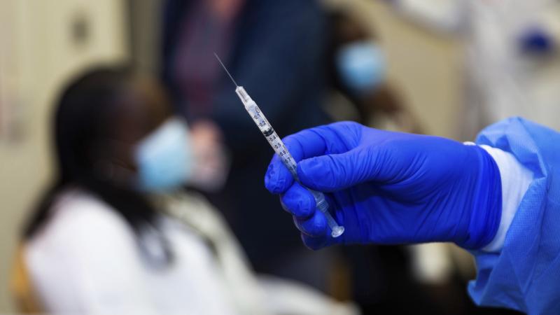A doctor prepares to administer a vaccine injection at New York-Presbyterian Lawrence Hospital in Bronxville, N.Y., in January. The Food and Drug Administration has approved emergency use authorization of the Pfizer/BioNTech vaccine for patients ages 12 t A doctor prepares to administer a vaccine injection at New York-Presbyterian Lawrence Hospital in Bronxville, N.Y., in January. The Food and Drug Administration has approved emergency use authorization of the Pfizer/BioNTech vaccine for patients ages 12 t