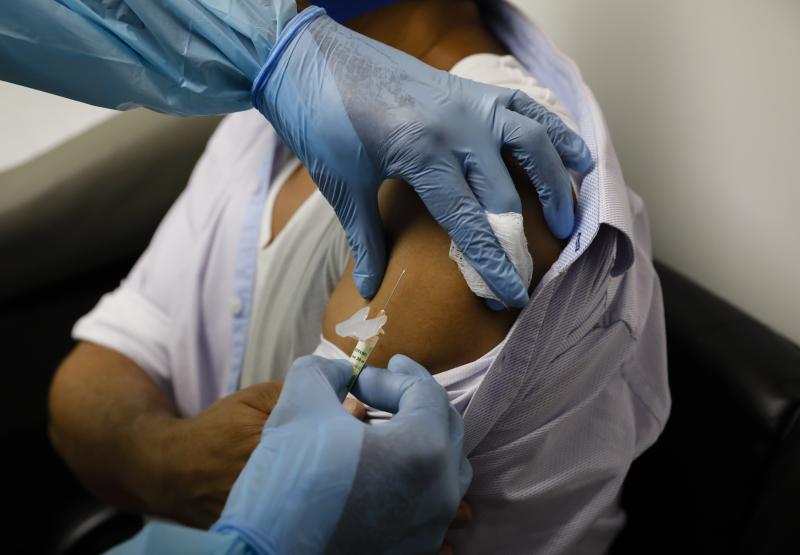 A volunteer in a clinical trial for an experimental COVID-19 vaccine receives an injection last month at Research Centers of America in Hollywood, Fla. A volunteer in a clinical trial for an experimental COVID-19 vaccine receives an injection last month at Research Centers of America in Hollywood, Fla.