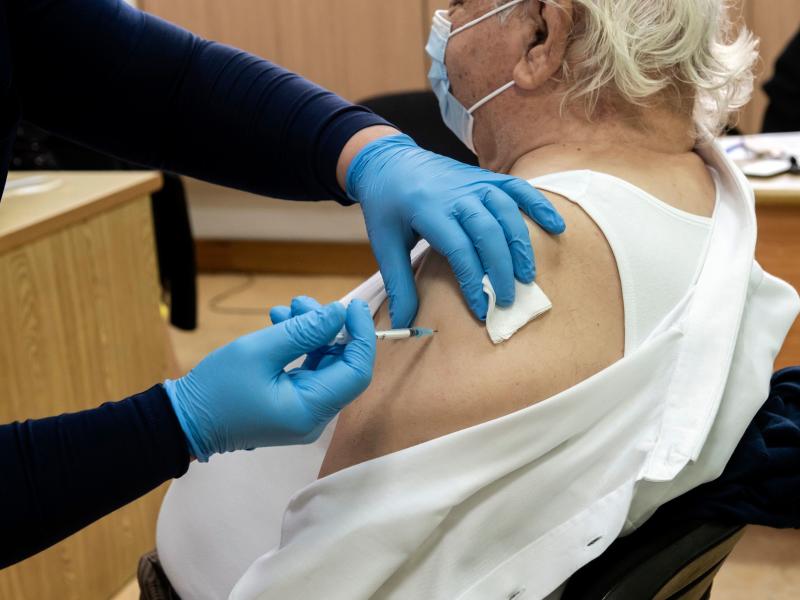 A healthcare worker administers a dose of the coronavirus vaccine to an elderly at a health center in the Cypriot coastal city of Limassol on February 8, 2021. A healthcare worker administers a dose of the coronavirus vaccine to an elderly at a health center in the Cypriot coastal city of Limassol on February 8, 2021.
